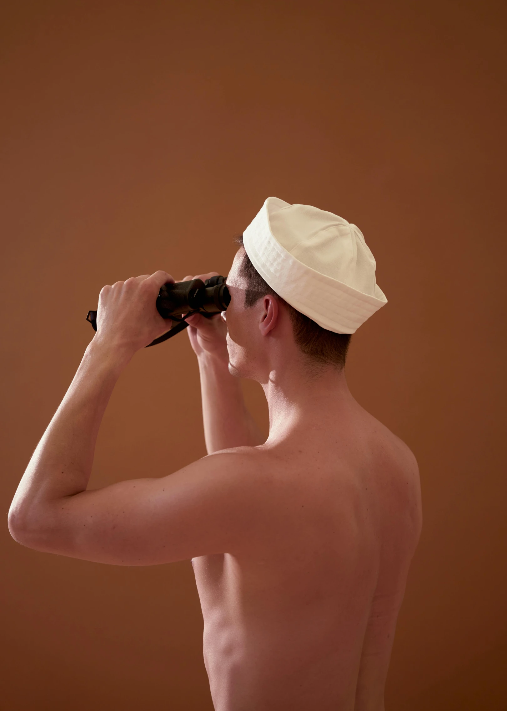 a man in a hat looking through a pair of binoculars, by Alison Geissler, minimalism, wearing a white bathing cap, barechest, ignant, slide show