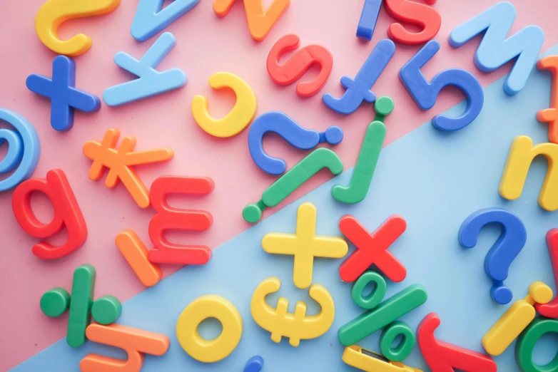 a pile of colorful plastic letters on a pink and blue surface, pexels, letterism, math equations, roman numerals, colorful computer screen, teacher