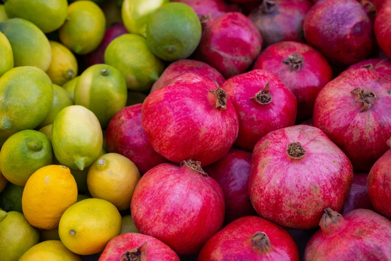 a pile of pomegranates sitting on top of each other, by Jay Hambidge, pexels, green magenta and gold, raspberry banana color, an olive skinned, amanda lilleston