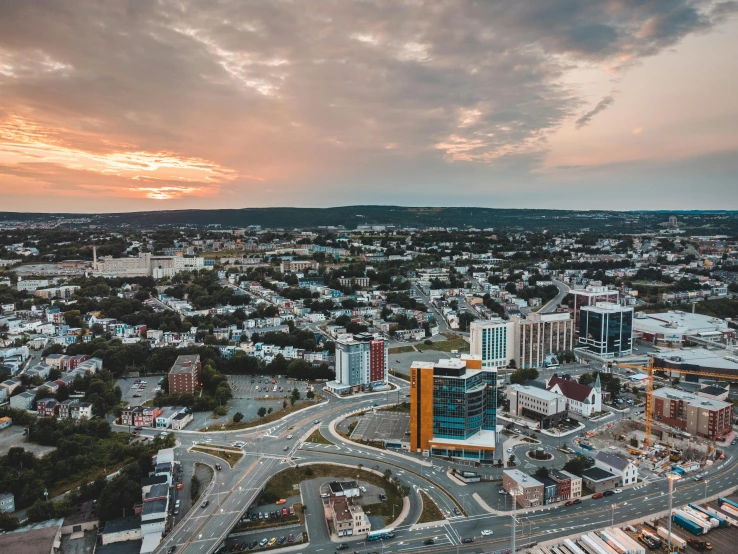 an aerial view of a city at sunset, by Brian Snøddy, pexels contest winner, grey, quebec, high quality photo, summer evening