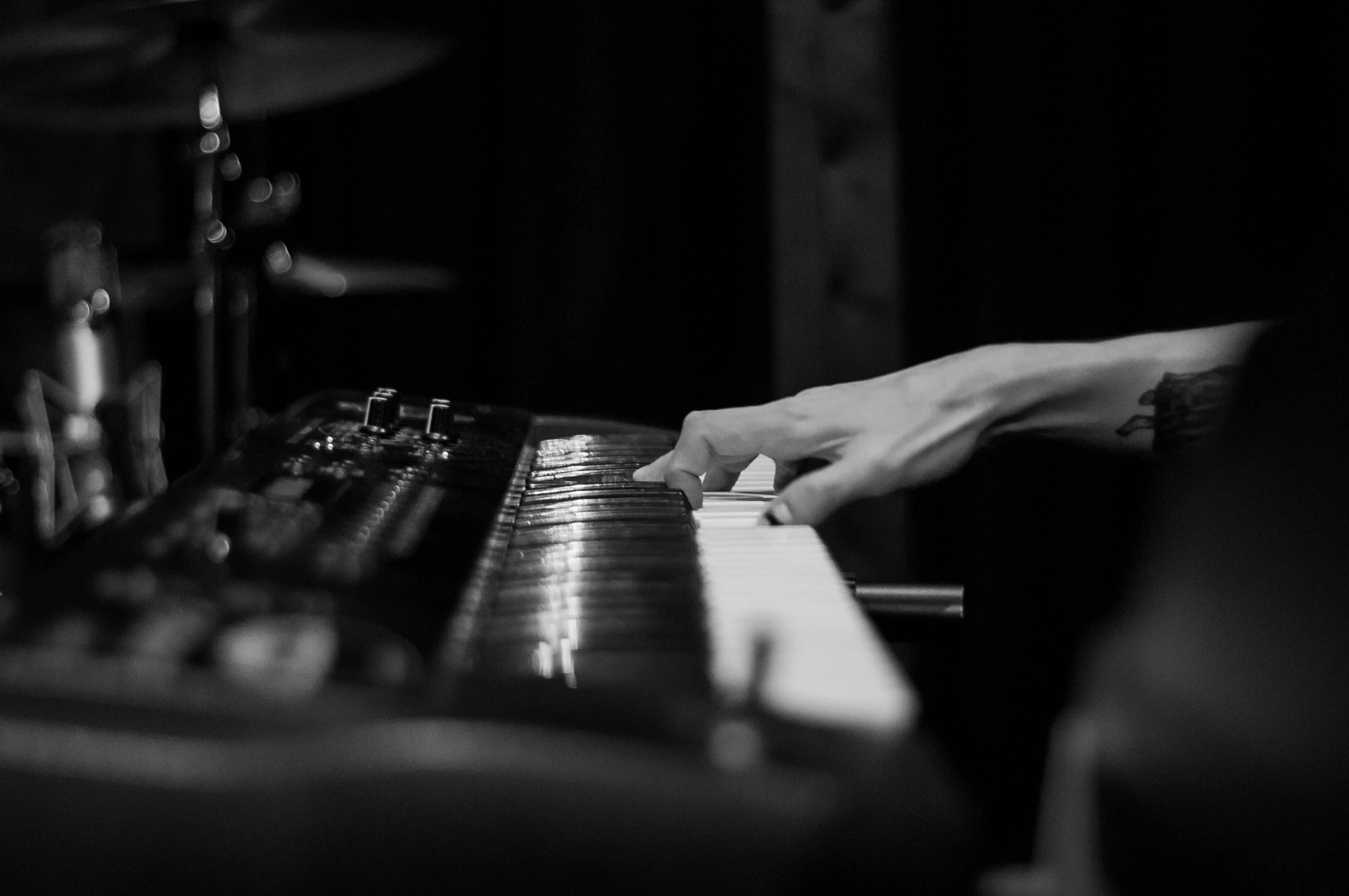 a close up of a person playing a piano, a black and white photo, by Mathias Kollros, unsplash, philip selway (drums), corinne day, concert, yaroslav tokar