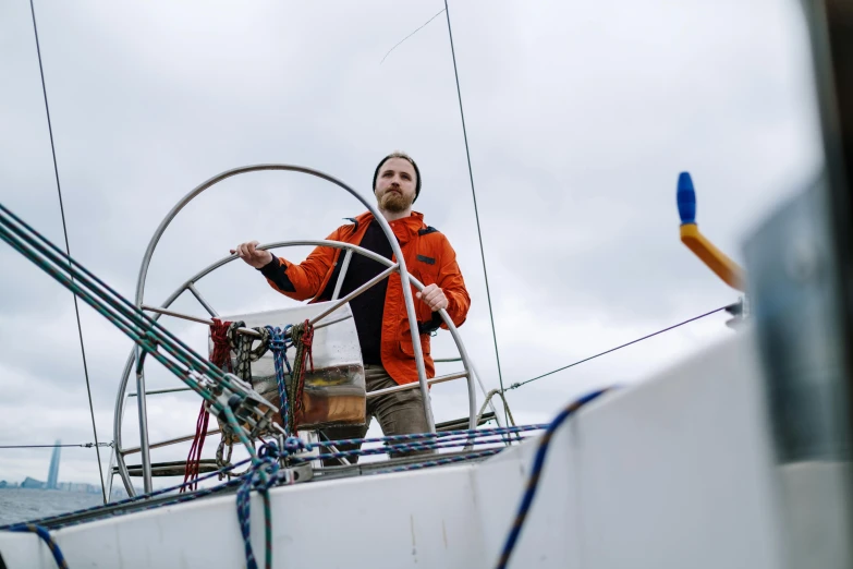 a man standing at the helm of a sailboat, by Jóhannes Geir Jónsson, new objectivity, production photo, humans exploring, we go