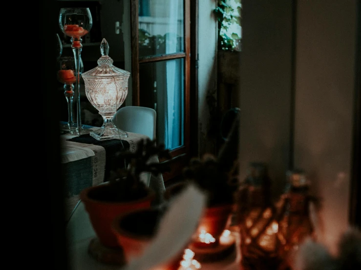 a couple of wine glasses sitting on top of a table, pexels contest winner, rococo, glowing jar, looking outside, home display, glowing details