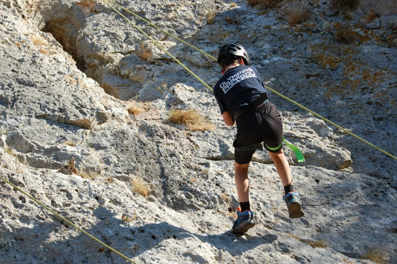 a man climbing up the side of a mountain on a rope, a photo, avatar image, alexandros pyromallis, tournament, profile photo