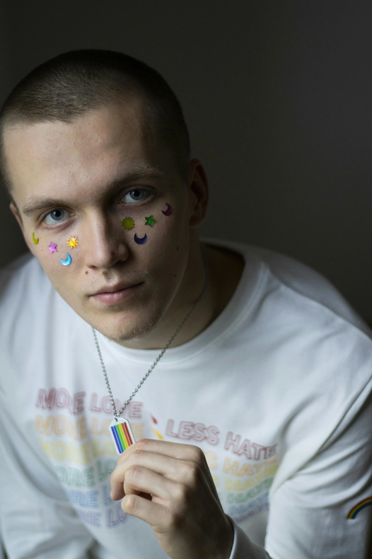 a man with paint all over his face, an album cover, inspired by Alexander Litovchenko, trending on reddit, graffiti, pride month, vitalik buterin, profile image, shaven face