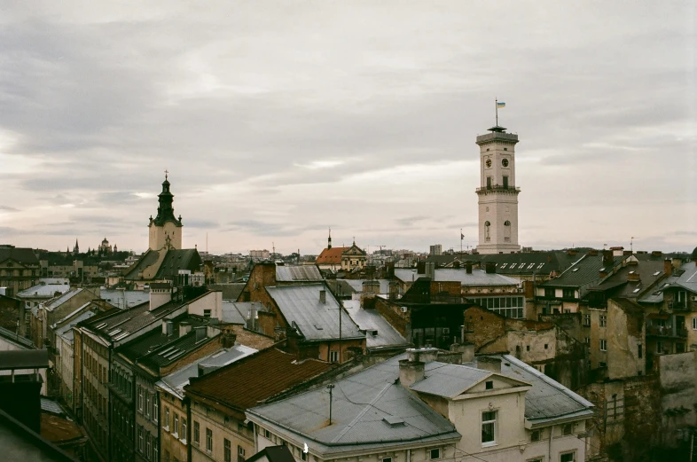 a large clock tower towering over a city, by Emma Andijewska, unsplash contest winner, baroque, vegetated roofs, gray skies, 2 0 0 0's photo, ukraine