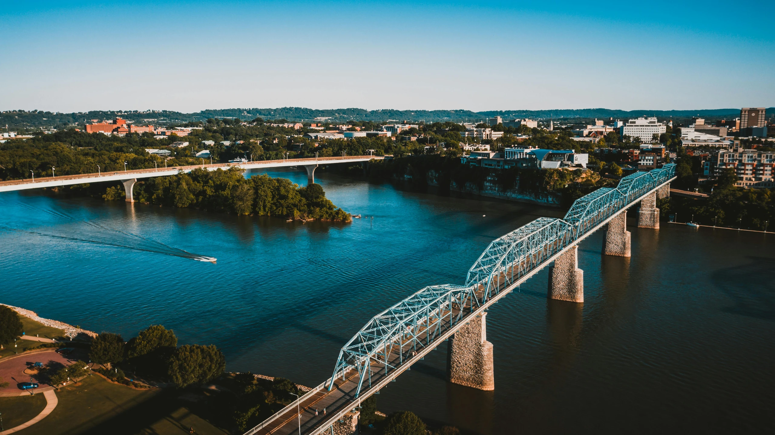 a bridge over a large body of water, a photo, by Dan Frazier, pexels contest winner, tn, entire city in view, blue river in the middle, slide show