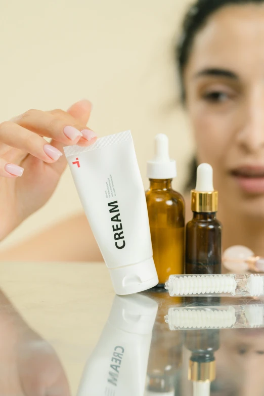 a close up of a person holding a bottle of lotion, a picture, vials, middle eastern skin, brown, facial