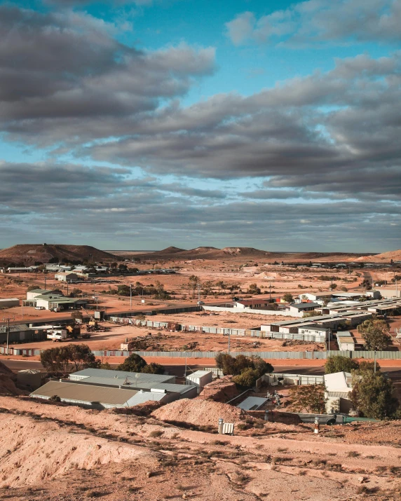 a small town in the middle of a desert, by Lee Loughridge, trending on unsplash, “ iron bark, slide show, prison complex, coloured photo