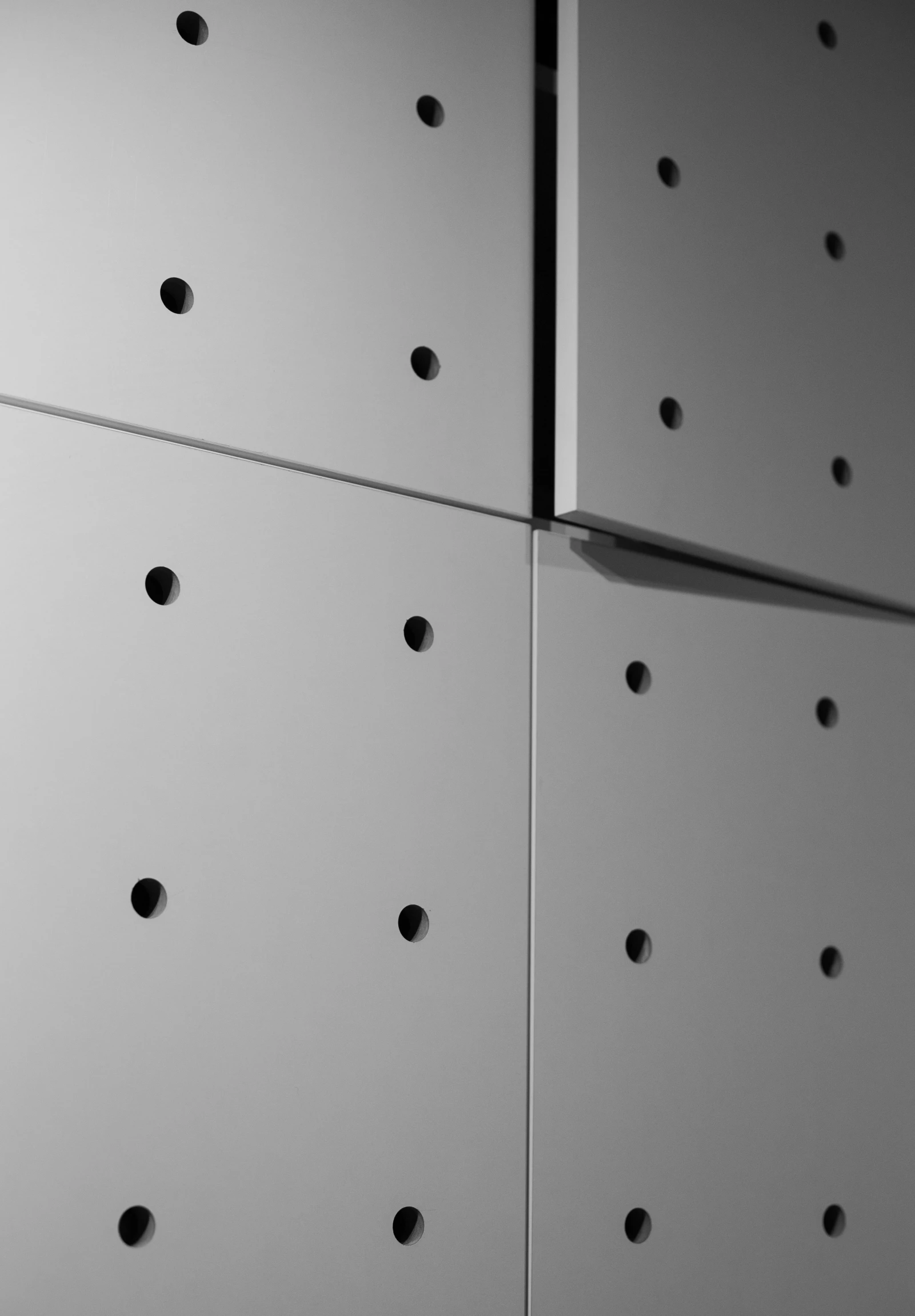 a black and white photo of a wall with holes, an ambient occlusion render, inspired by Karel Dujardin, cupboards, metal handles, medium close-up, office ceiling panels