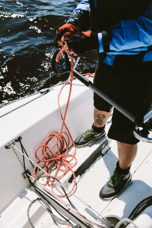 a man that is standing on a boat in the water, belaying, zoomed in, wiring, profile image