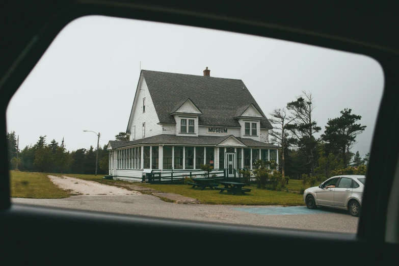 a house with a picnic table in front of it, by Carey Morris, pexels contest winner, viewed through the cars window, cottage, seaside victorian building, drive in movie theater