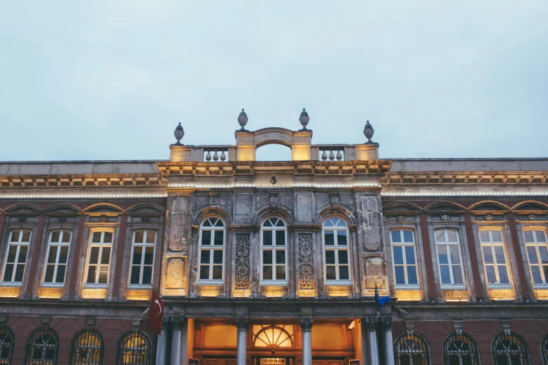 a large building with a clock on the front of it, by Emma Andijewska, pexels contest winner, art nouveau, early evening, helmond, war theatre, persian style architecture