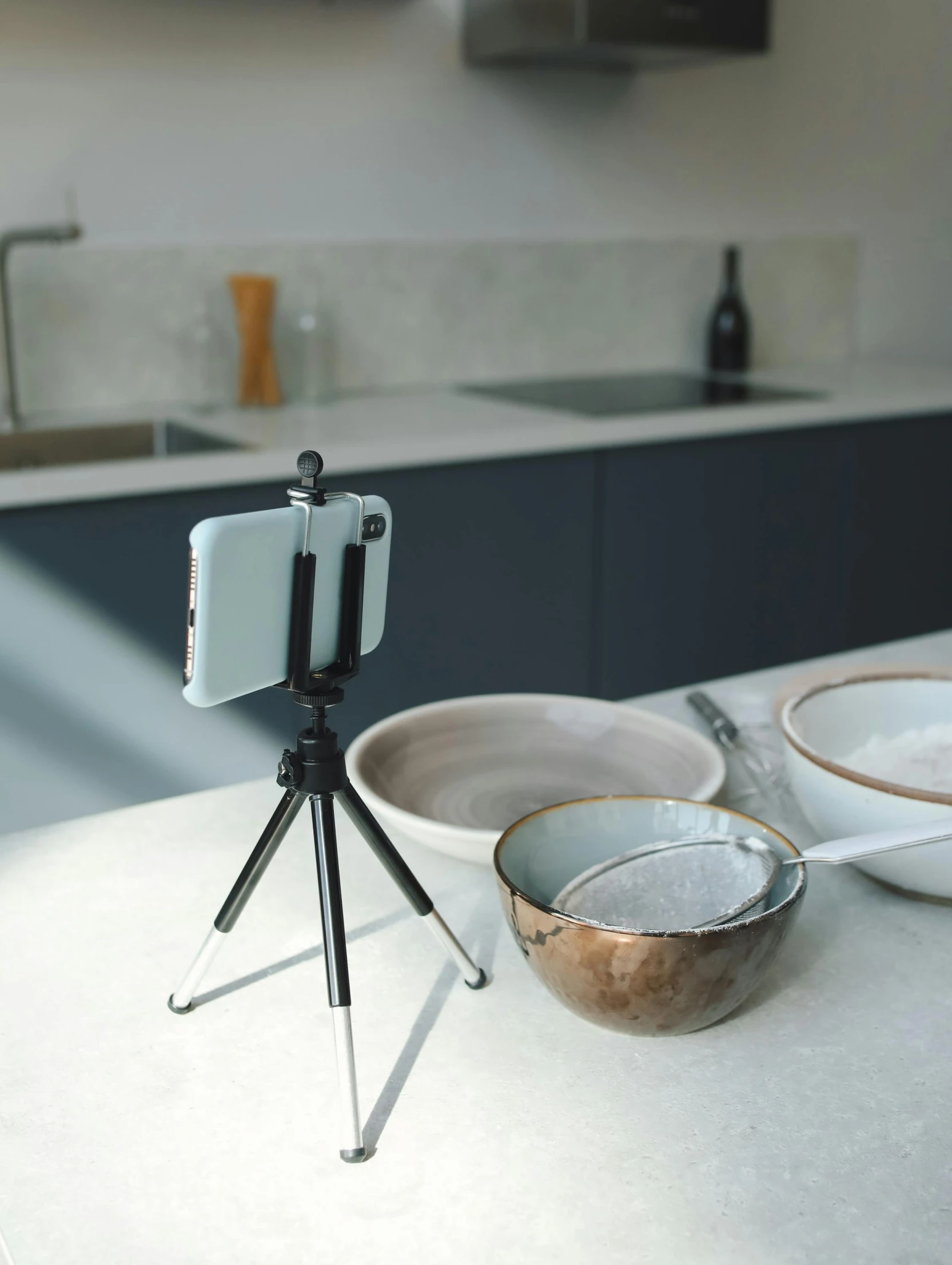 a camera that is sitting on a tripod, inspired by Diego Giacometti, video art, on kitchen table, smartphone footage, detailed product image, british stopmotion