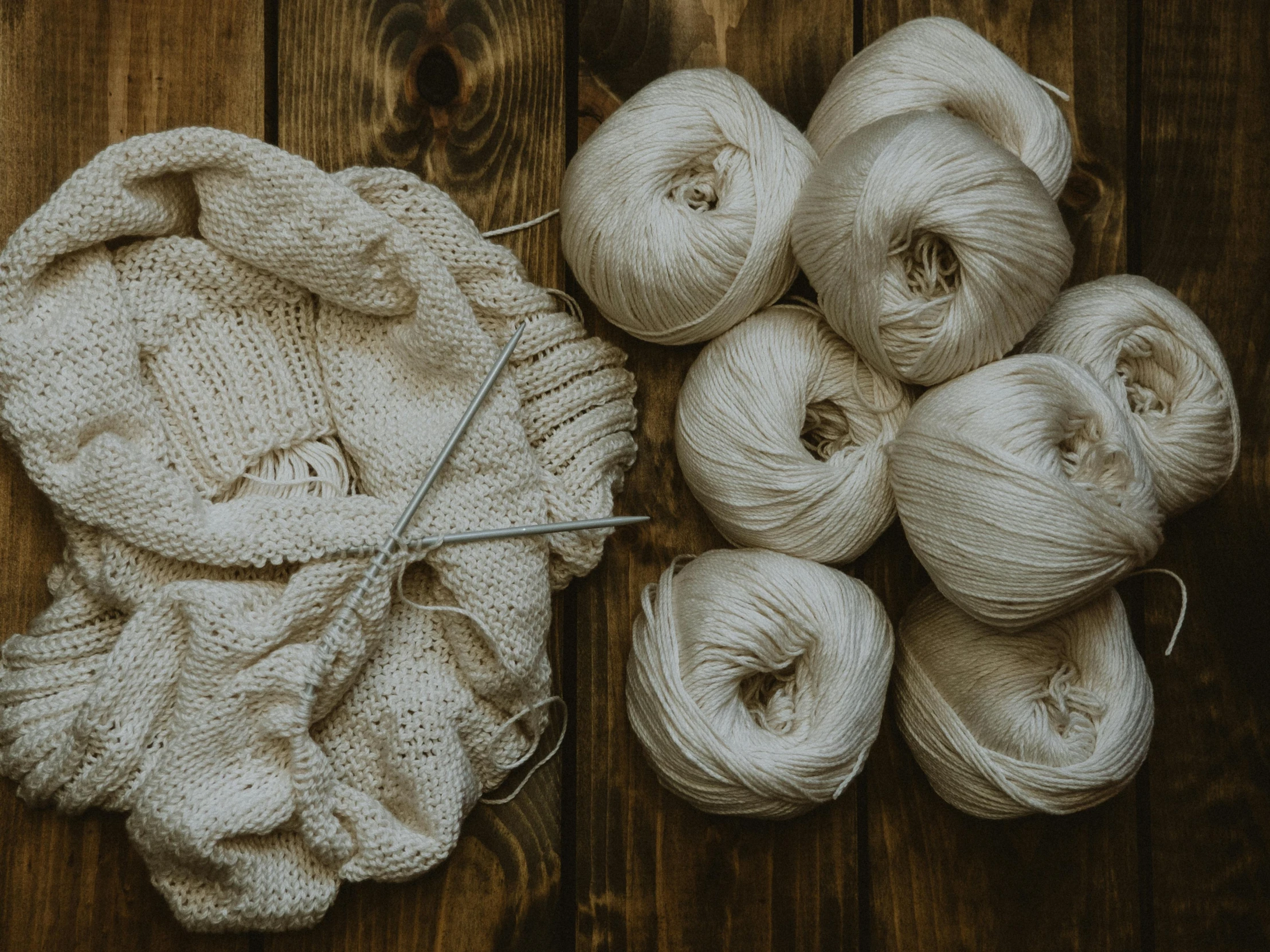 a pile of yarn sitting on top of a wooden table, by Jessie Algie, pexels contest winner, arts and crafts movement, silver，ivory, casual, 15081959 21121991 01012000 4k, modeled