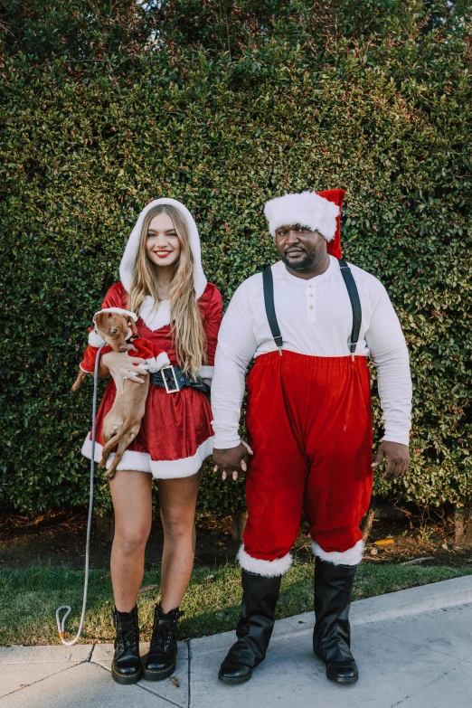 a man and a woman dressed as santa claus and a dog, an album cover, by Ryan Pancoast, pexels, shaquille o'neil pregnant, sydney sweeney, thick thighs, los angeles ca