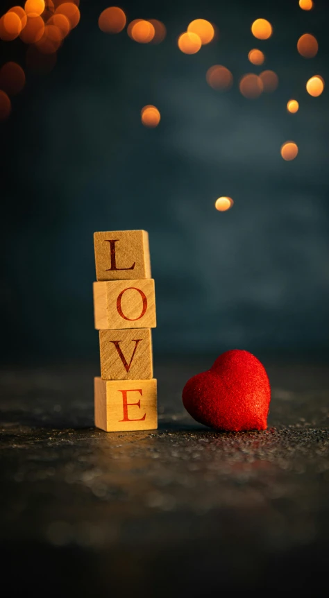 a wooden block with the word love next to a red heart, by Julia Pishtar, romanticism, bokeh photograph, square, demur, paul barson