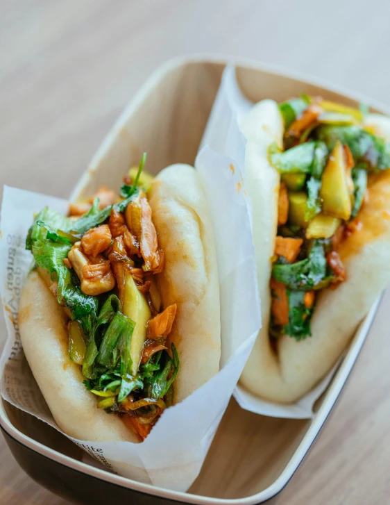 a couple of buns sitting on top of a wooden table, food court, profile image, bowl filled with food, ramps