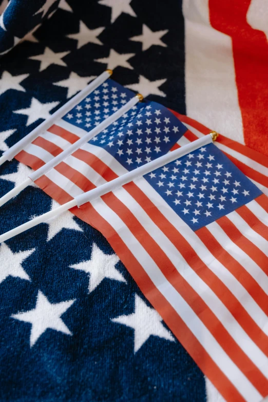 a pair of scissors sitting on top of an american flag, a portrait, shutterstock, navy flags, 2 5 6 x 2 5 6 pixels, parade floats, upclose