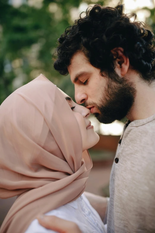 a man kissing a woman wearing a hijab, pexels contest winner, still shot from movie, h3h3, square, ( ( theatrical ) )