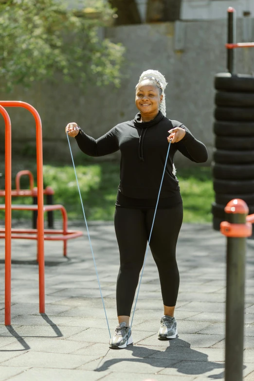 a woman doing a jump rope exercise in a park, by Robert Medley, essence, curvy build, square, profile image