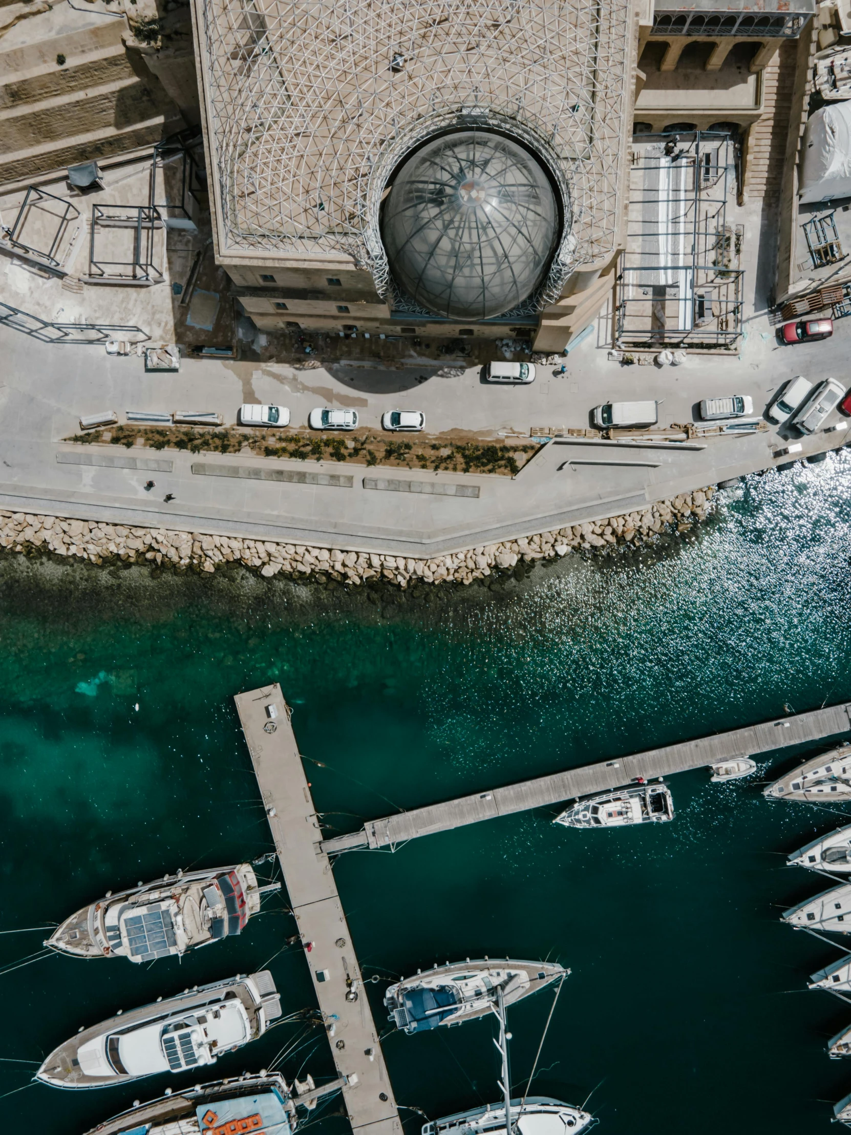 a number of boats in a body of water, by Sebastian Spreng, pexels contest winner, renaissance, high angle security camera feed, harbour in background, split near the left, helicopter view