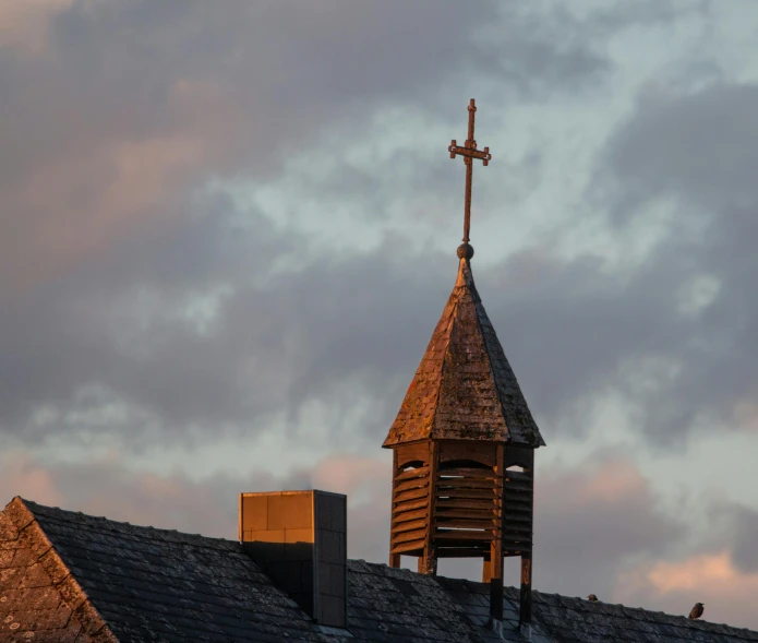 a church steeple with a cross on top of it, by Jan Tengnagel, unsplash, evening light, fan favorite, rooftop, brown