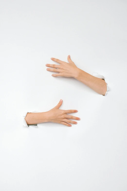 two hands reaching out of a hole in a wall, an album cover, inspired by Cornelia Parker, trending on pexels, conceptual art, white sleeves, plain background, technologies, patricia piccinini