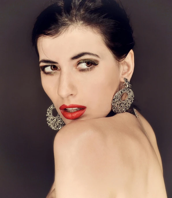 a woman with red lipstick posing for a picture, inspired by Hedi Xandt, pixabay, art nouveau, silver earring, studio lighting”, taken in the late 2010s, neri oxman