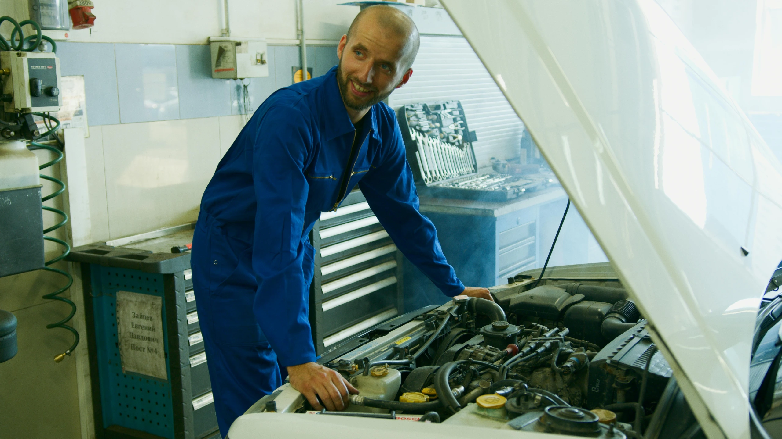 a man working on a car engine in a garage, by Thomas Häfner, pexels contest winner, renaissance, smug face, blue print, caucasian, 15081959 21121991 01012000 4k