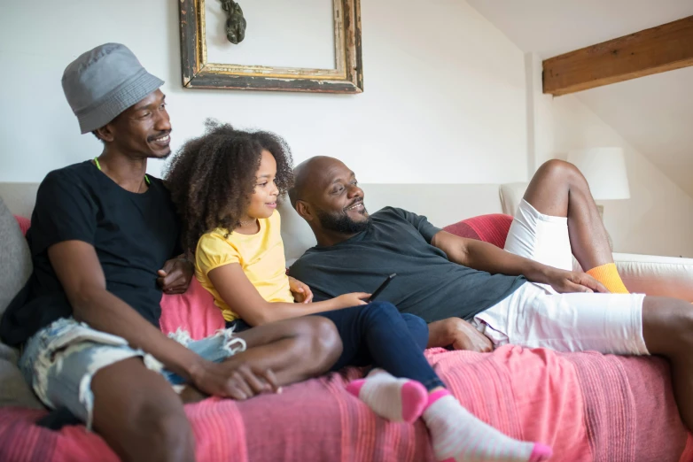 a group of people sitting on top of a bed, pexels, fatherly, everything fits on the screen, african american, on a couch