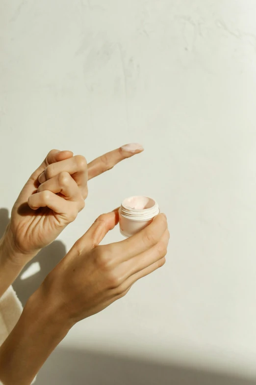 a woman brushing her teeth with a toothbrush, trending on pexels, visual art, cream, hand model, holding a tin can, skin texture natural