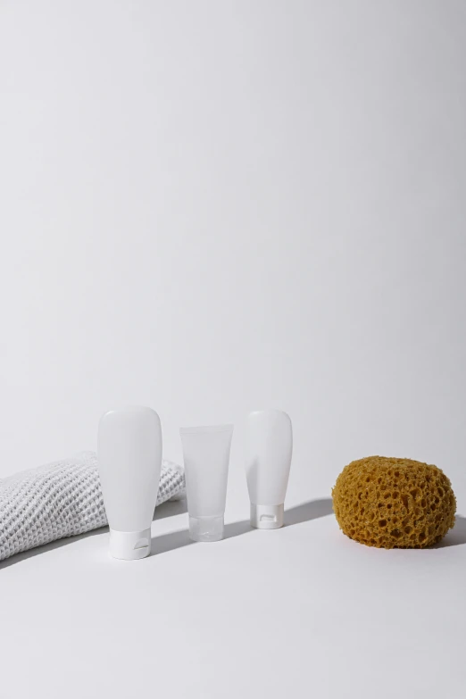 a group of toothbrushes sitting on top of a table, organic shapes, shower cap, grey, dwell