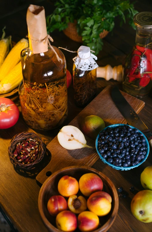 a wooden table topped with bowls of fruit and a bottle of wine, a still life, pexels, renaissance, syrup, indigo, panoramic shot, seasonal