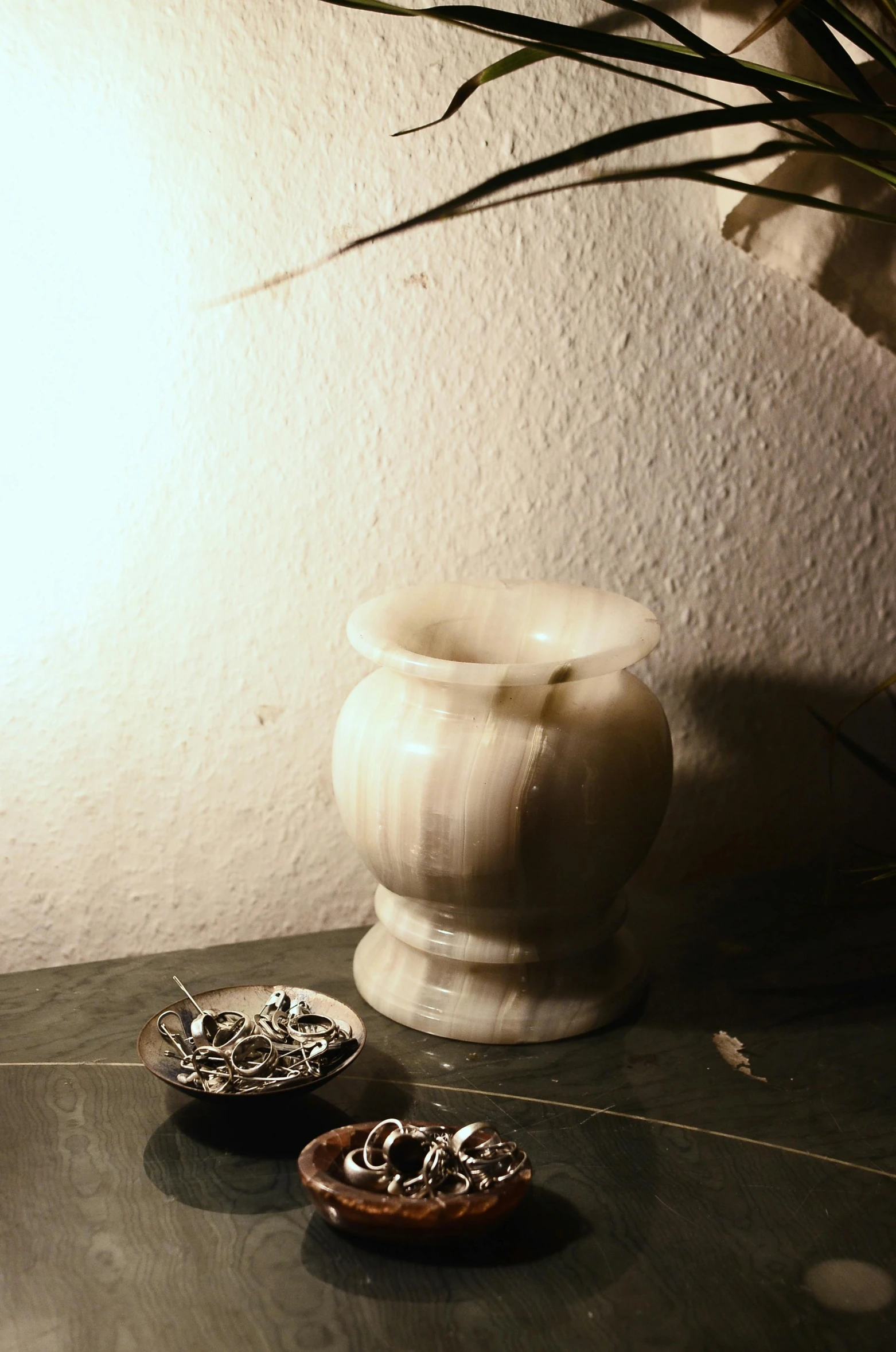 a couple of donuts sitting on top of a table, a marble sculpture, inspired by Elsa Bleda, unsplash, renaissance, sconces, broken vase, silver，ivory, 1960s color photograph