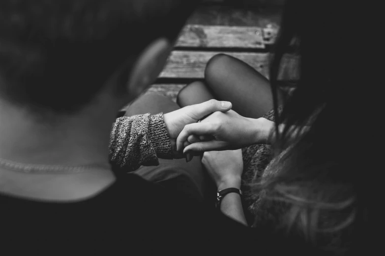 a black and white photo of a couple holding hands, by Emma Andijewska, pexels, sitting down, girl, 15081959 21121991 01012000 4k