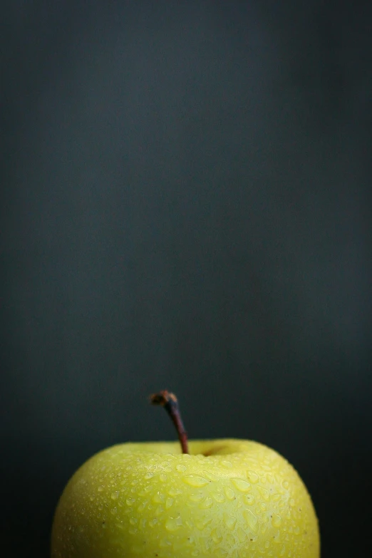 a green apple sitting on top of a wooden table, a picture, by Andrew Domachowski, postminimalism, black backdrop!, pear, food photography”, yellow and charcoal