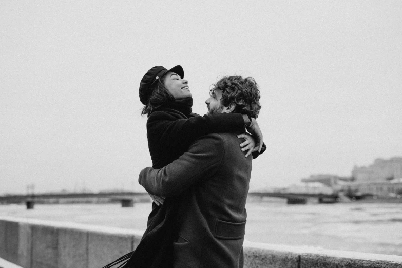 a black and white photo of a man hugging a woman, by Anita Malfatti, pexels contest winner, saint petersburg, happy friend, & a river, 😭 🤮 💕 🎀