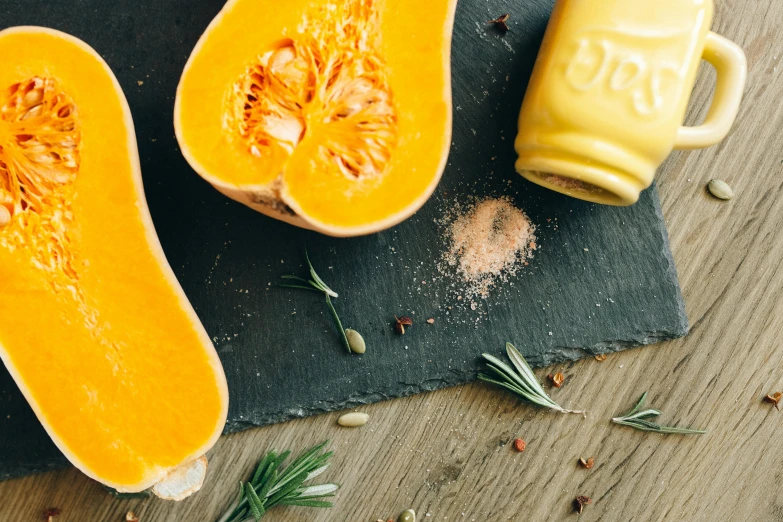 a couple of butternuts sitting on top of a cutting board, by Carey Morris, pexels, pumpkin, mustard, juice, thumbnail