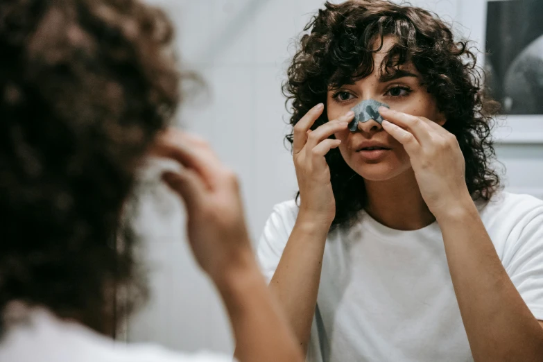 a woman brushing her teeth in front of a mirror, pexels contest winner, hyperrealism, cute bandaid on nose!!, black eye mask, with blue skin, made of lab tissue