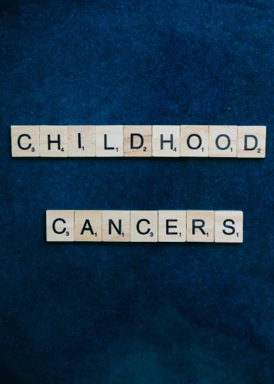 the word childhood cancer spelled in scrabbles on a blue background, an album cover, promo image, 2 5 6 x 2 5 6 pixels, dark. no text, university