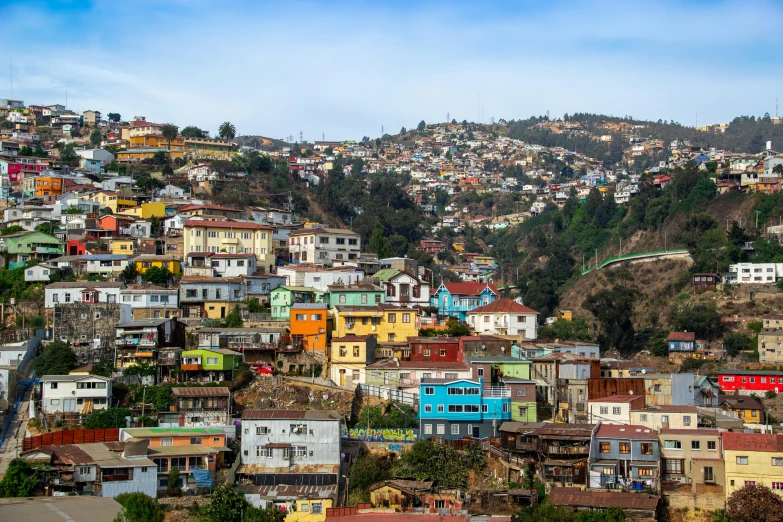 a city filled with lots of colorful buildings, by Meredith Dillman, pexels contest winner, quito school, log houses built on hills, color image, square, panoramic