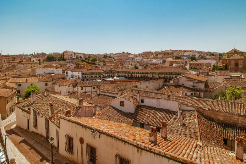 a view of a town from the top of a building, by Juan Giménez, pexels contest winner, baroque, plain background, square, background image