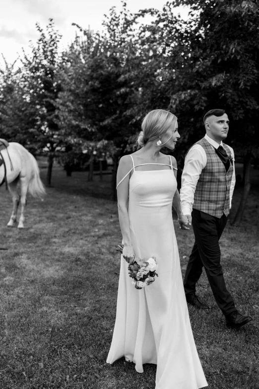 a man and a woman standing next to a horse, a black and white photo, by Antoni Brodowski, wedding, walking through the trees, 🤬 🤮 💕 🎀, late summer evening