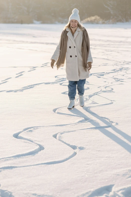 a woman walking across a snow covered field, trending on pexels, land art, wearing a long coat, hidden message, ( ( theatrical ) ), white