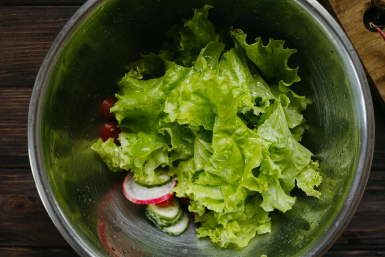 a metal bowl filled with lettuce and radishes, by Julia Pishtar, pexels, work in progress, red green, ignant, with a soft