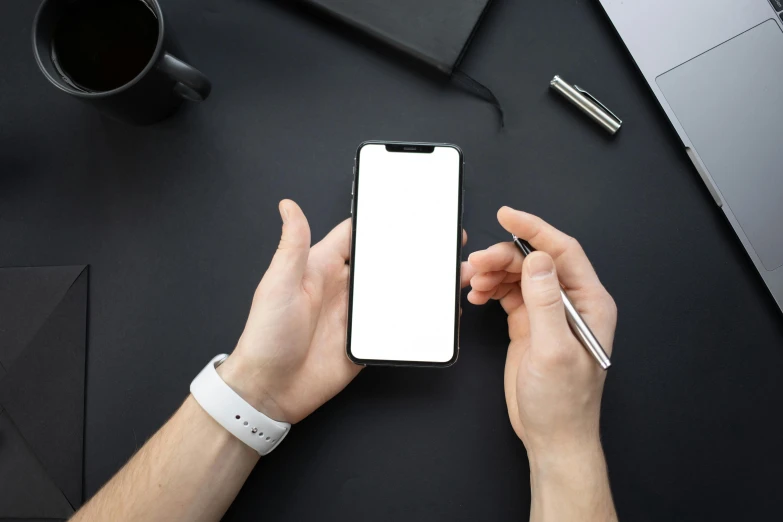a person holding a smart phone next to a laptop, trending on pexels, white on black, round corners, holding pencil, professional iphone photo