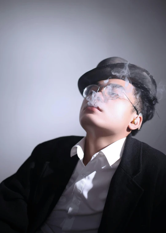 a man in a suit smoking a cigarette, inspired by Rudy Siswanto, neo-dada, transparent glasses, profile image, trending photo, large)}]