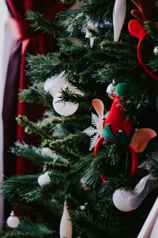 a close up of a christmas tree with decorations, inspired by Ernest William Christmas, pexels contest winner, folk art, elf ears, dressed in a beautiful, a cozy, closeup of an adorable