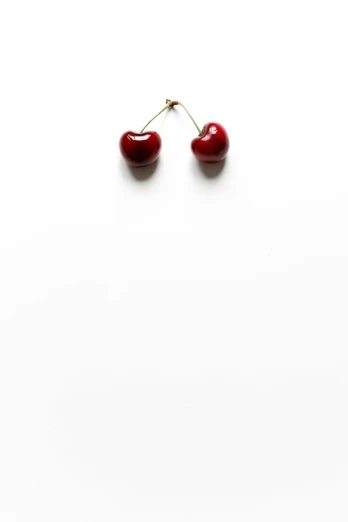 two cherries sitting on top of a white surface, a picture, by Leo Leuppi, 2 5 6 x 2 5 6, earring, shin jeongho, heartbreak